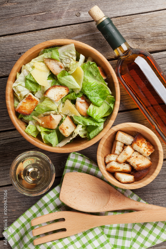 Fresh healthy caesar salad and white wine Fresh healthy caesar salad and white wine