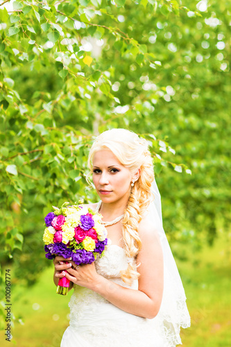 Happy bride with wedding bouquet