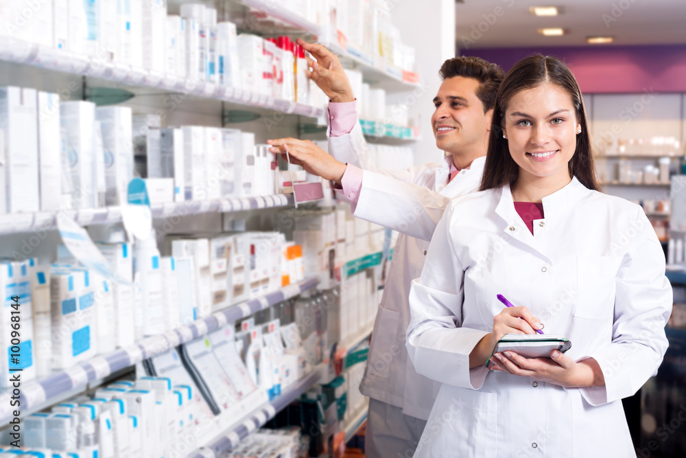 Portrait of two friendly pharmacists working