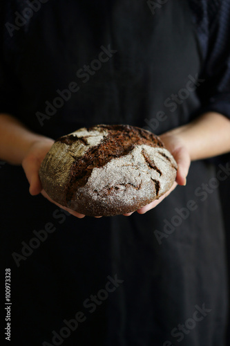 rustic bread in baker hand