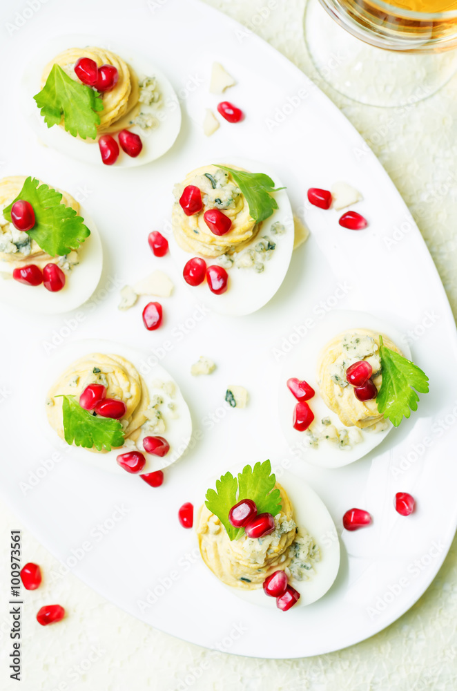 Blue cheese deviled eggs with pomegranate
