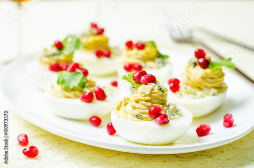 Blue cheese deviled eggs with pomegranate