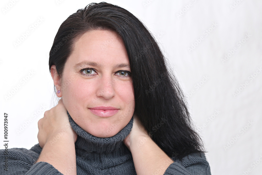 happy woman wearing winter clothes and posing in front of a white background happy woman wearing winter clothes and posing in front of a white background