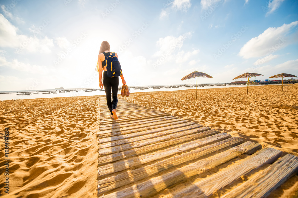 Woman walking on the sandy beach