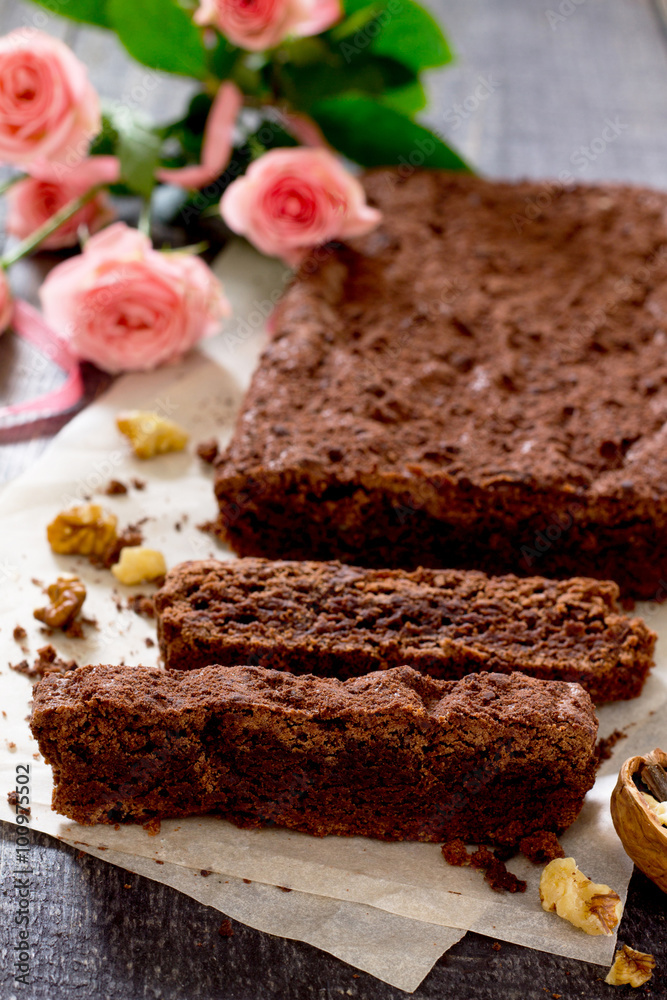 American chocolate cake with walnut on a dark background