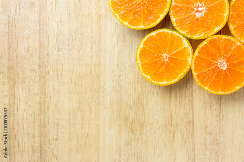 Slice fresh orange fruit  on wood background with copy space