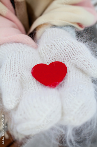 red heart in warm gloves