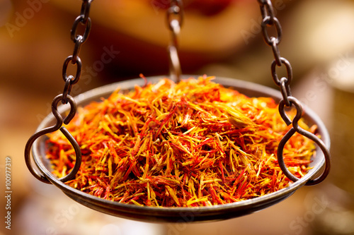 dried saffron spice in vintage  bowl weights