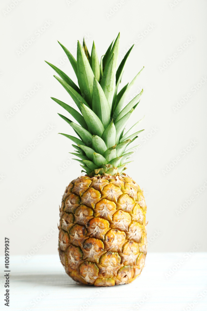 Ripe pineapple on a white wooden table Ripe pineapple on a white wooden table