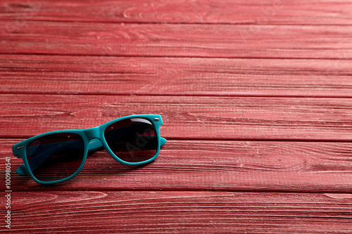 Sunglasses on a red wooden table