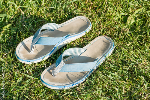 Blue used flip-flops on the grass