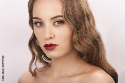 Closeup portrait of young beautiful woman with gorgeous makeup and long hair