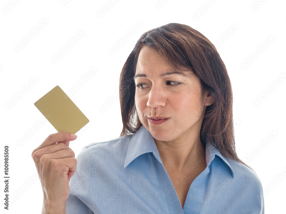 Photograph of a young mixed race woman looking warily at her credit card or gift card. Photograph of a young mixed race woman looking warily at her credit card or gift card.