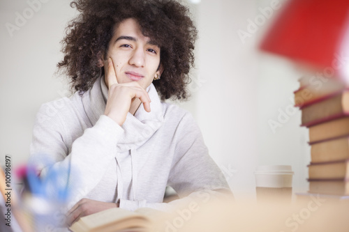 Portrait of male student studying at table