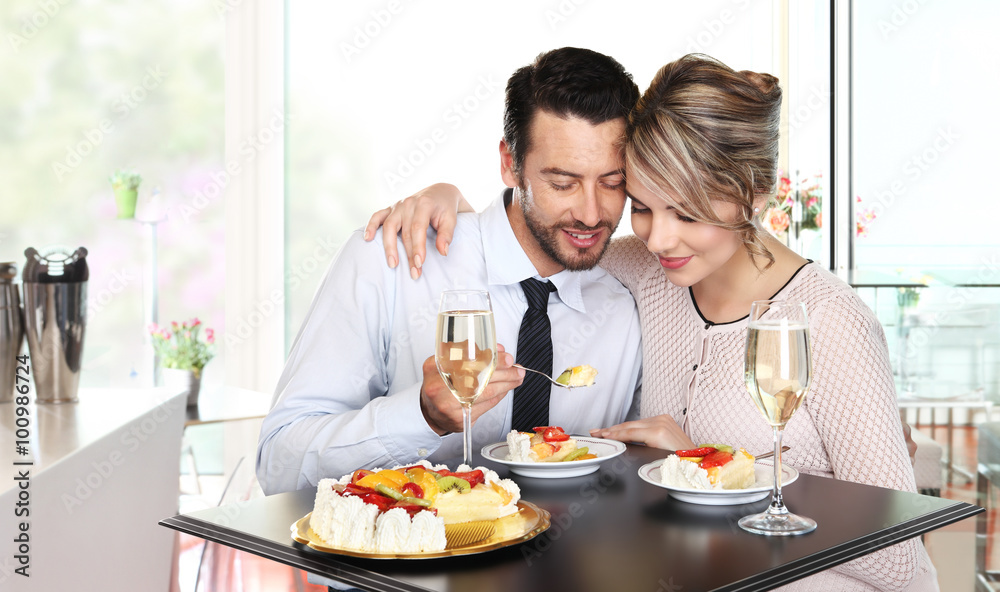 happy couple at the bar with wine and fruit cake, love concept