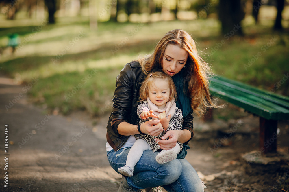 Fototapeta premium young family walking in the park
