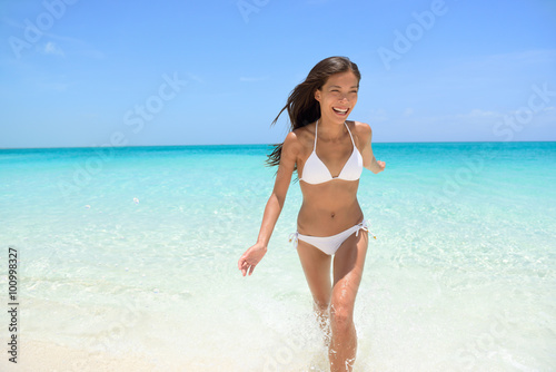 Cheerful Woman Running at Beach Summer Fun © Maridav