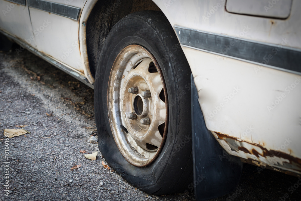 Close up old car flat tire