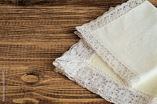 Handkerchiefs. Handkerchiefs with a decorative trim on a brown wooden background.