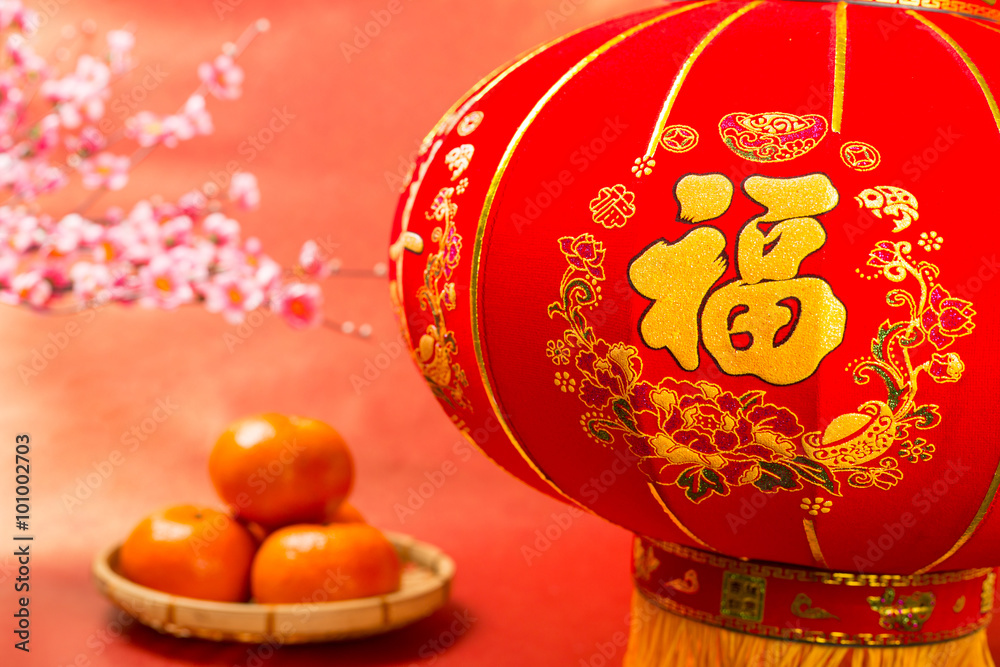 Chinese new year decoration with mandarine oranges, cherry blossom, lantern with red background