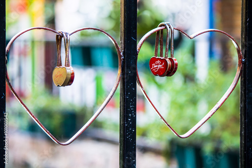 Red Heart Shaped Lock Concept of Love. / Red heart shaped lock concept of love hanging on heart rail bridge - retro styled. 