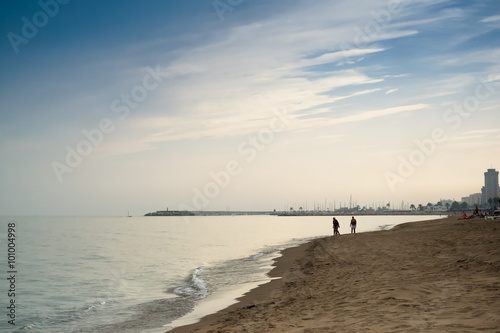 Family Walk At The Beach