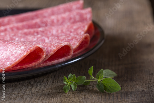 Salami slices on plate photo