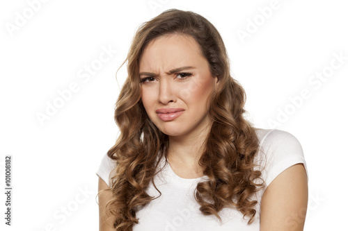 pretty disgusted girl on a white background