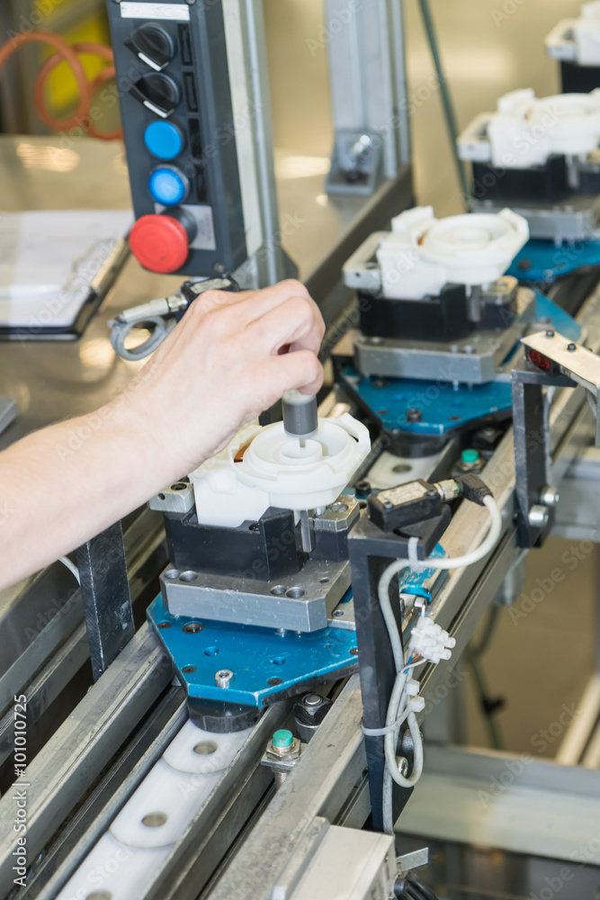 Hand of worker woman on the assembly line Hand of worker woman on the assembly line