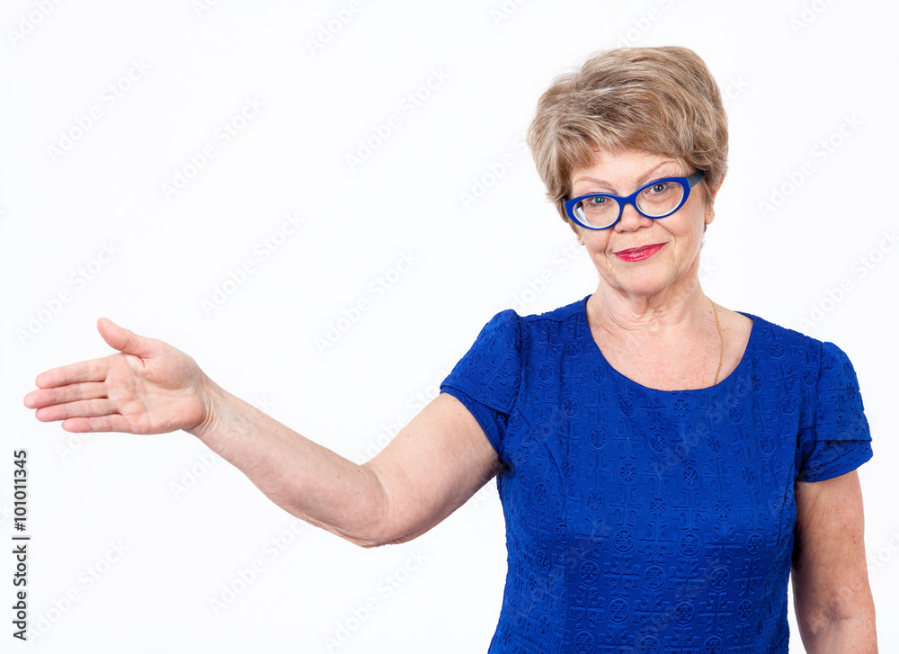 Positive Caucasian woman gesturing with hand to copyspace, white background