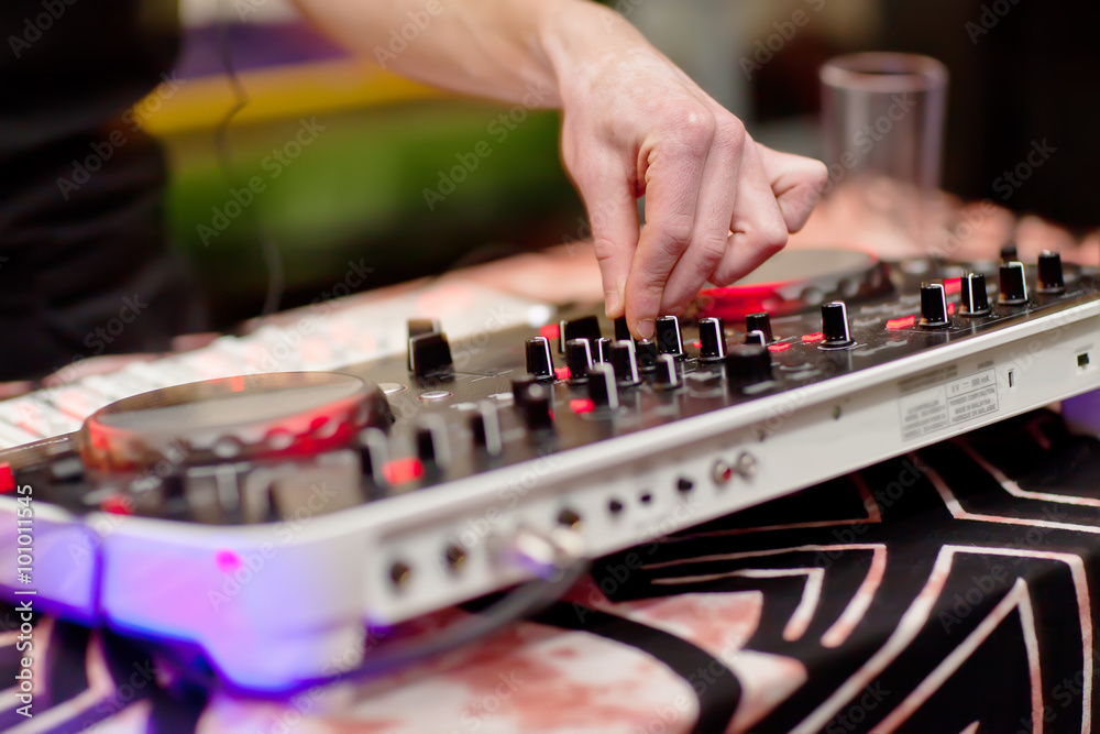 DJ mixing music on console at the night club DJ mixing music on console at the night club