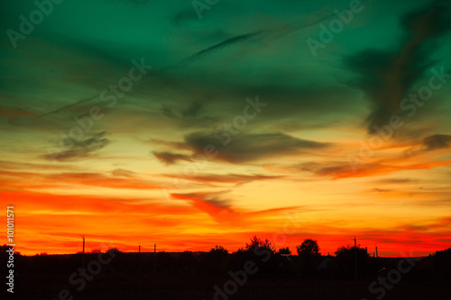 Rural landscape in evening at sunset with cloudy sky © vvvita
