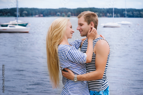 Portrait of a romantic couple in a striped T-shirt hugging and smiling, lifestyle, love, romance, relationships