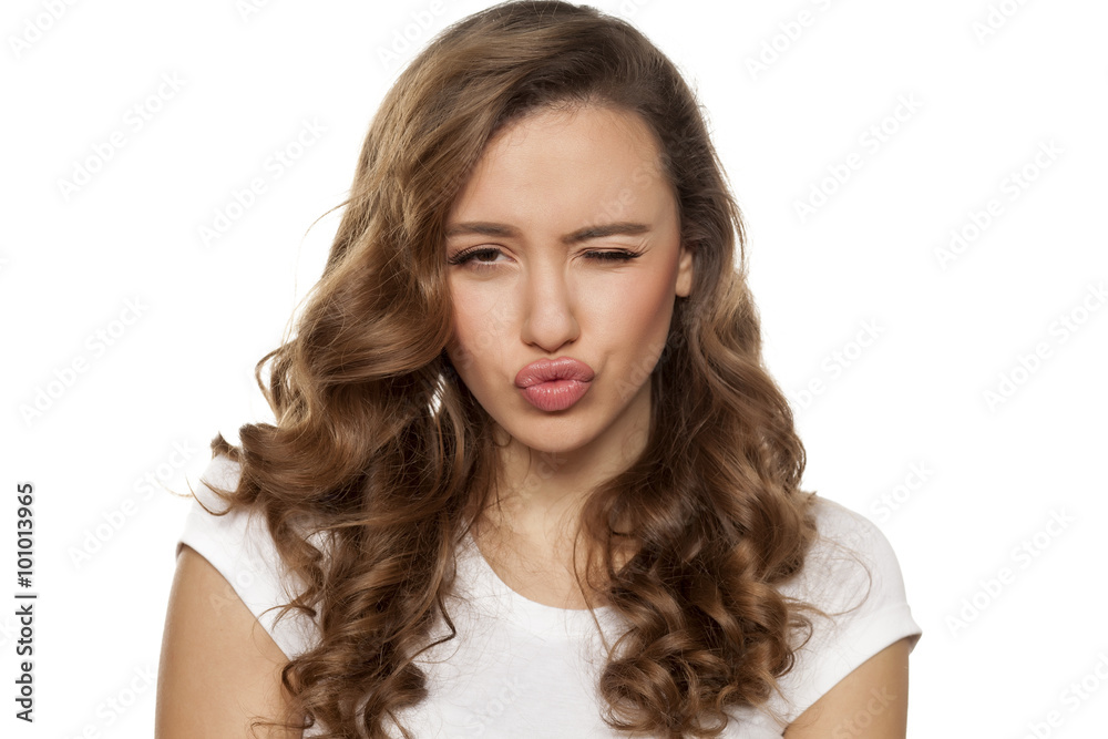 winking beautiful young woman with pursed lips winking beautiful young woman with pursed lips