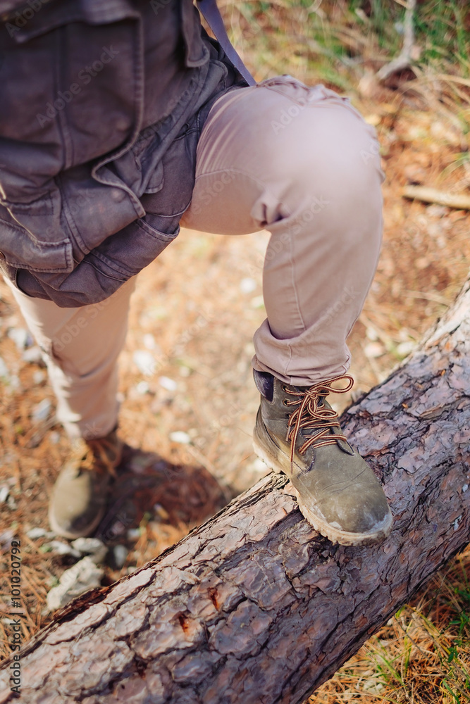 Hiker standing on tree trunk Hiker standing on tree trunk