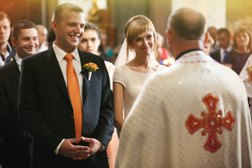 gorgeous romantic happy bride and groom having wedding ceremony