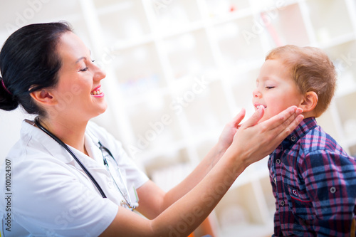 Medical doctor with child in office. Sick child to the doctor