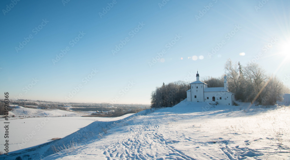  Church on the hill in background of a winter landscape