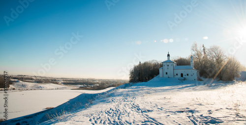  Church on the hill in background of a winter landscape
