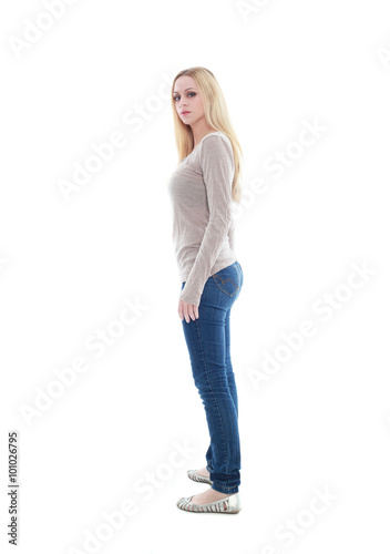 beautiful young woman with long blonde hair wearing a long sleeved cream shirt and gold necklace. standing pose, isolated on white background.