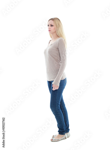 beautiful young woman with long blonde hair wearing a long sleeved cream shirt and gold necklace. standing pose, isolated on white background.