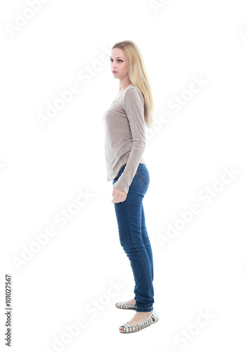 beautiful young woman with long blonde hair wearing a long sleeved cream shirt and gold necklace. standing pose, isolated on white background.