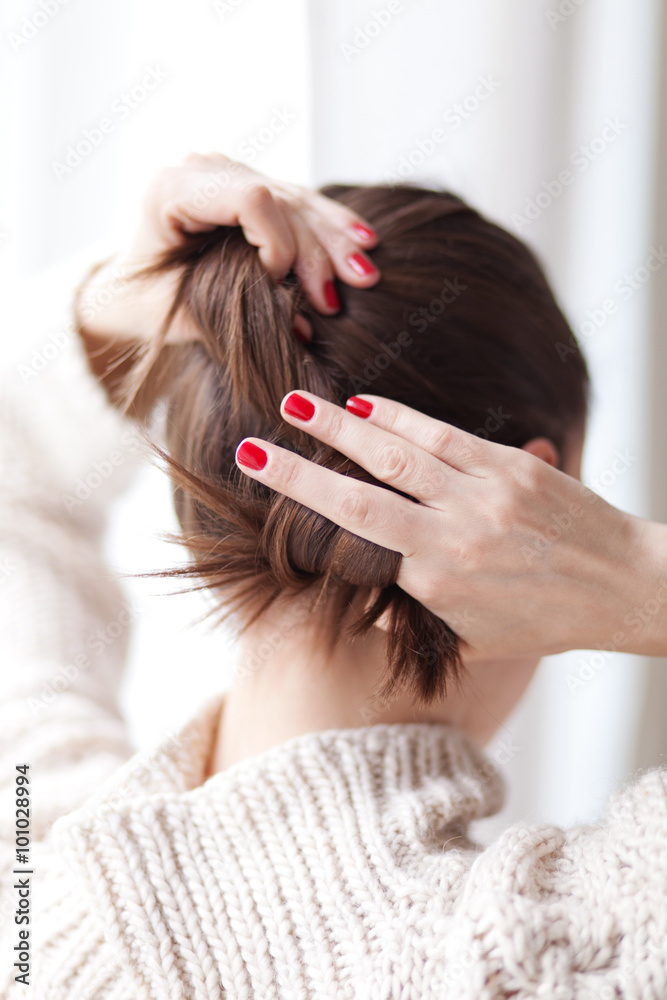 Fototapeta premium Woman making hair bun
