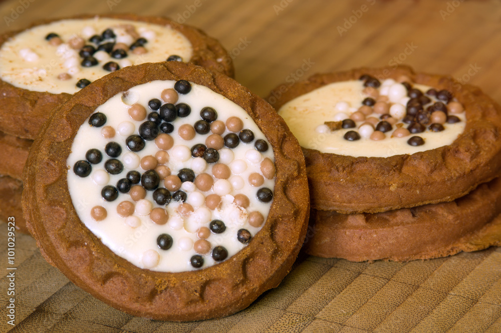 Cookies with glaze isolated on wooden background