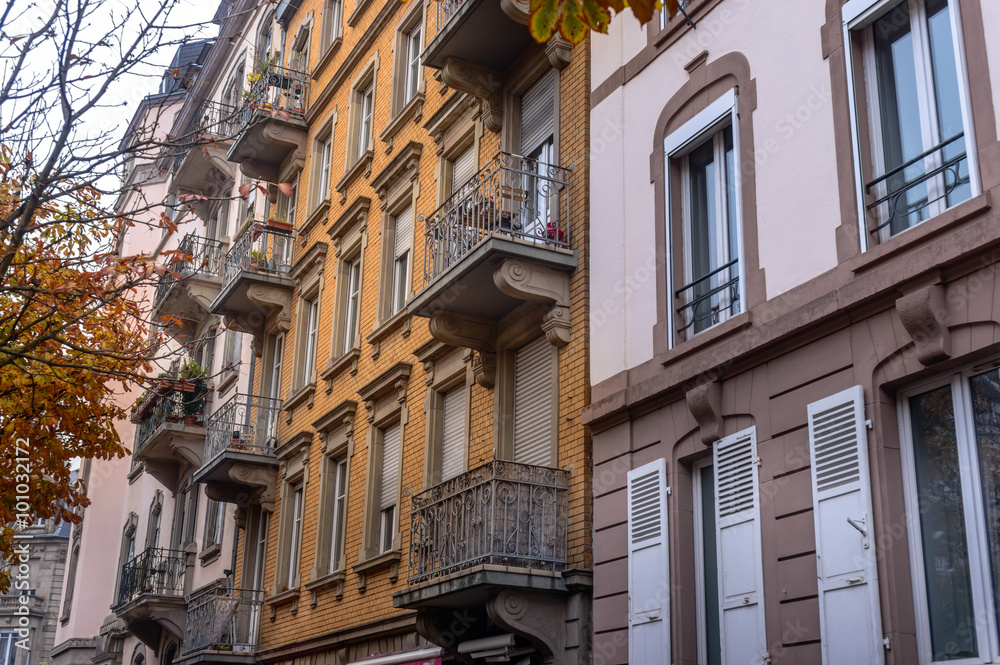 Facade of old European building with balcony autumn
