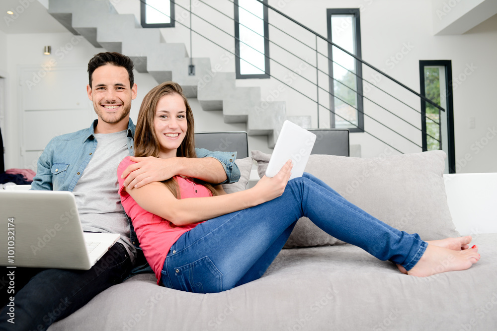 happy young couple relaxed on sofa in a beautiful modern design home happy young couple relaxed on sofa in a beautiful modern design home