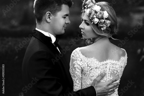 Sensual beautiful young blonde bride and handsome groom hugging