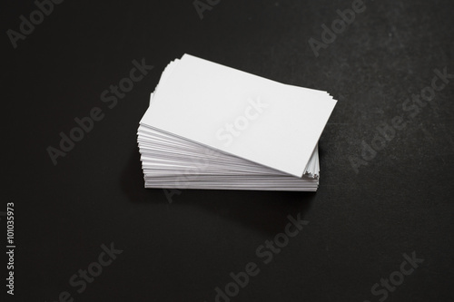 blank business cards stack up on Black background