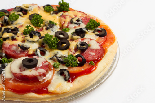 Pizza with tomatoes, salami, cheese and olives