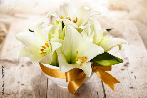 Fototapeta Naklejka Na Ścianę i Meble -  White lilies on table.